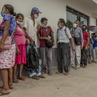 Chiriaco. Locals queue outside the Banco de la Nación to receive the government cash assistance