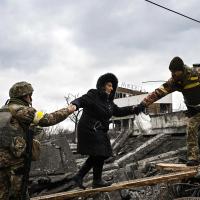 woman gets help from military to evacuate in the war in Ukraine