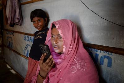 Mobile phones are both a lifeline for refugees such as this Rohingya-family stranded in a refuge camp ind Bangladesh - and a liability, putting them at risk of surveillance and location tracking. Photo: Munir uz Zama/Ritzau Scanpix