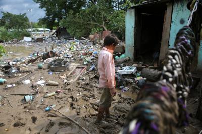 Boy looking at home destroyed by Hurricane