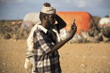 Man checking his phone for reception in the village of Faleyare in Northern Somalia