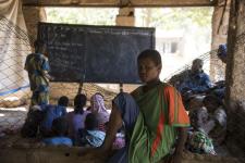 Poor classroom in a shed with young hopefull student from Mali